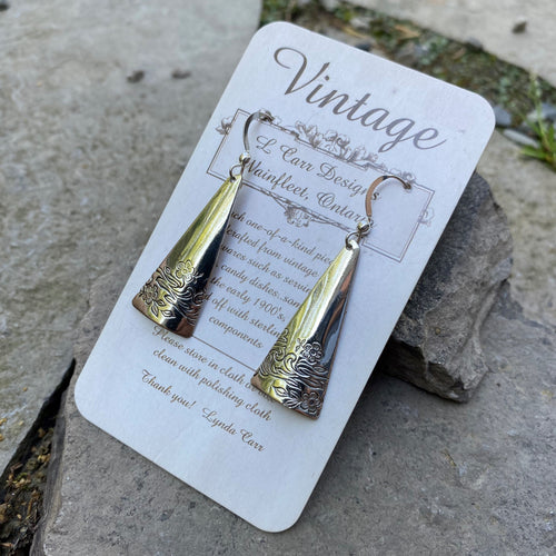 Elongated triangle earrings made from a vintage trivet and finished on short, sterling silver ear wires.