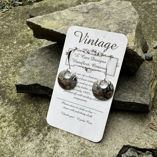 Circle earrings with small round cutout at top on short sterling silver fish hook wires vintage recycled bread plate restyled wearable art