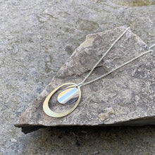 Load image into Gallery viewer, Cutout brass oval necklace solid silver oval centre dangle sterling silver chain recycled drum cymbal vintage silver plate wearable handmade art
