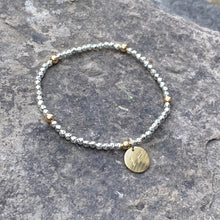 Load image into Gallery viewer, Beaded stretch bracelet circle brass charm recycled drum cymbal musical wearable art handmade Canadian artisan 
